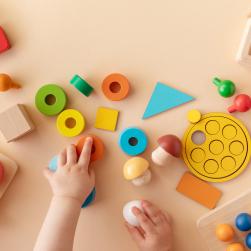 Photo d'une main de bébé avec des jeux en bois